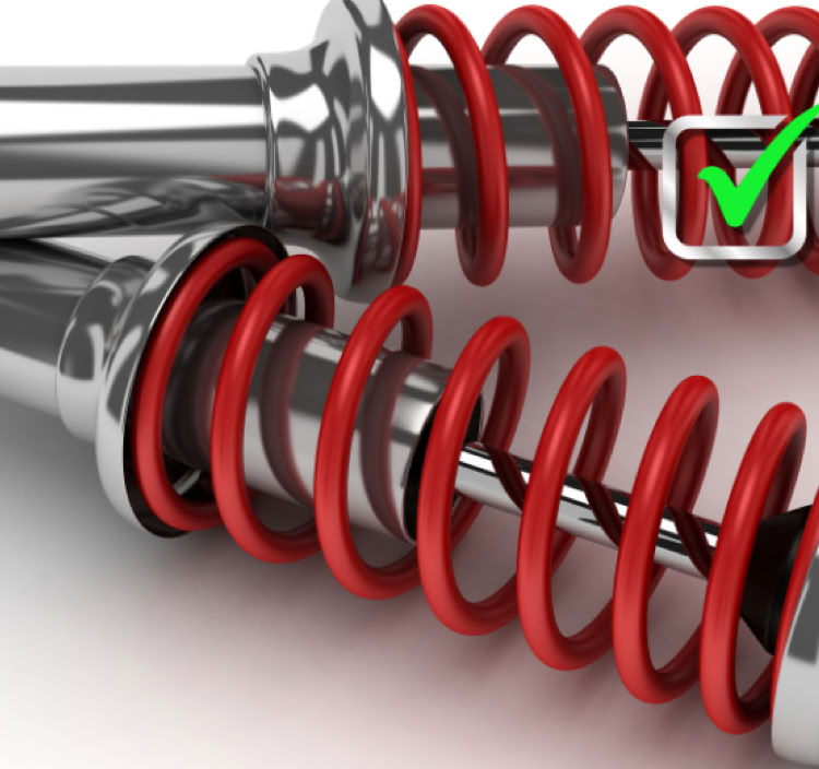 Two metallic shock absorbers with red springs, one featuring a green check mark.